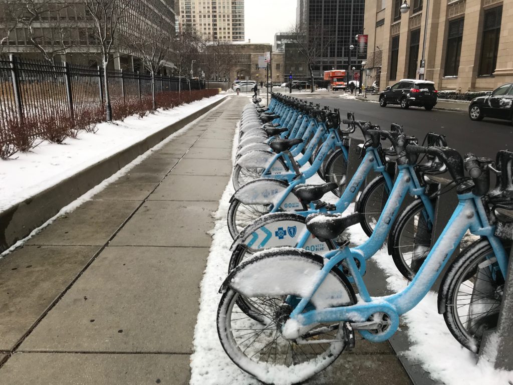 Line of snow covered Citi bikes